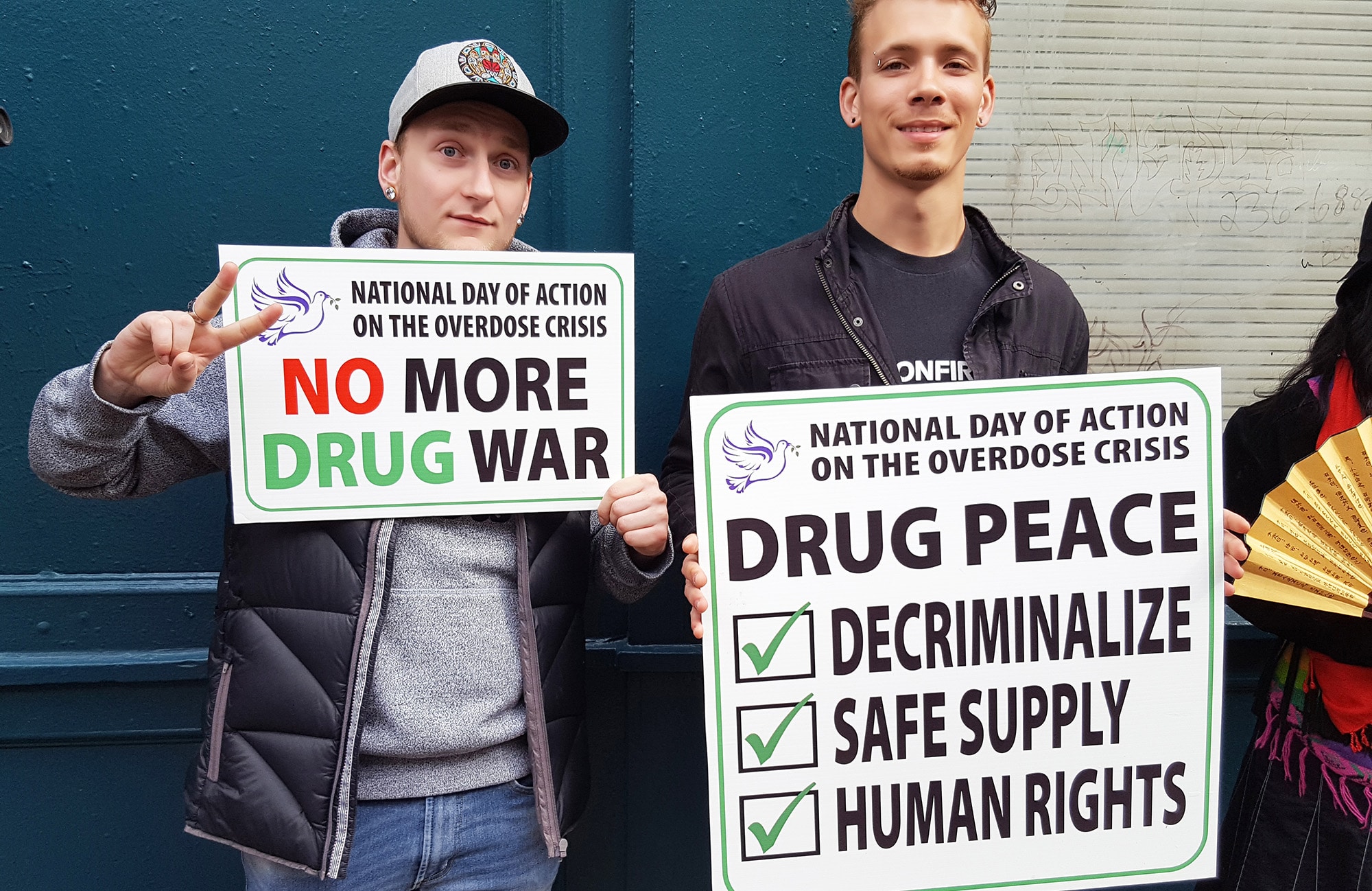 Two men holding of rally signs during National Day of Action 2019
