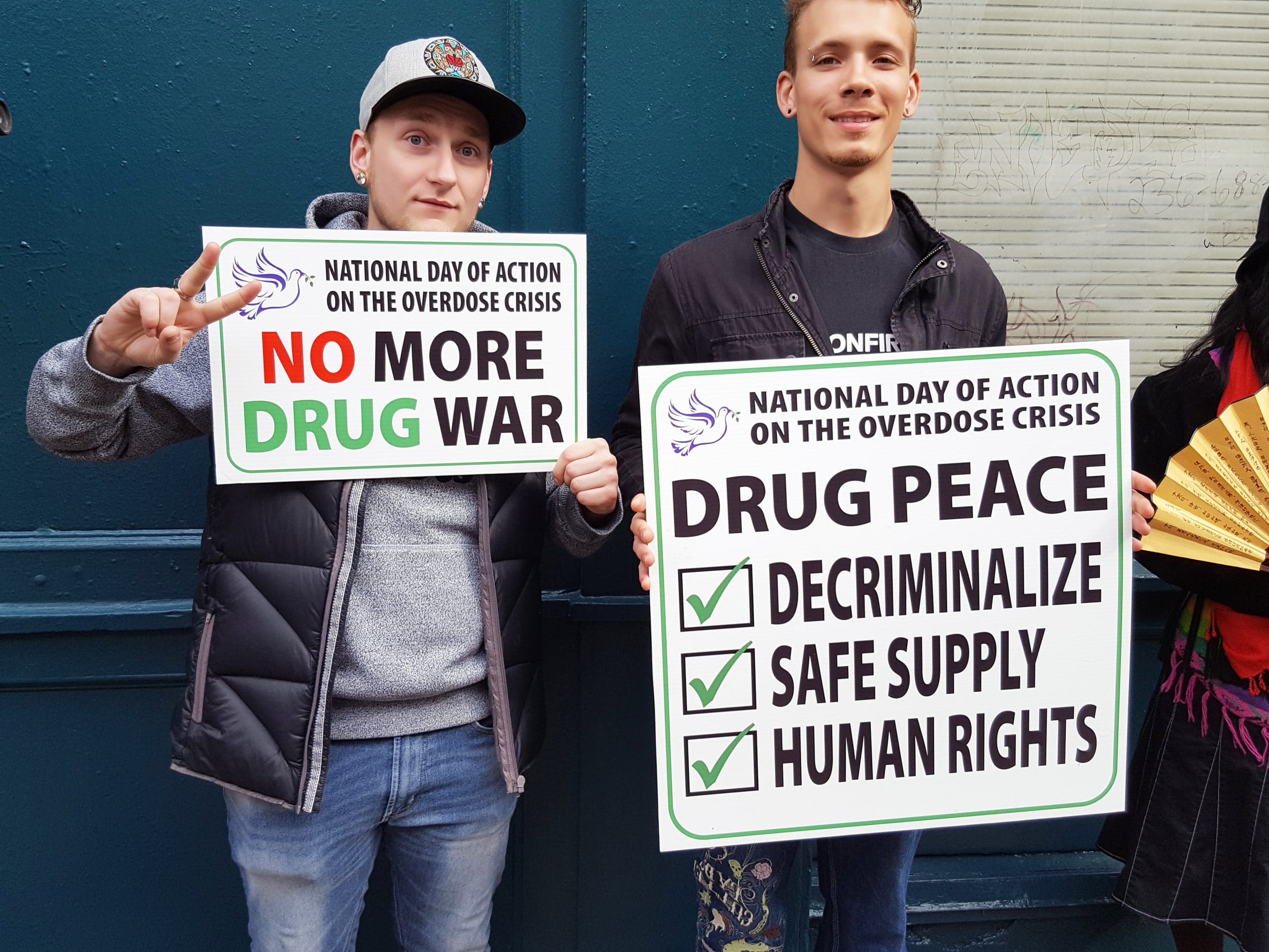 Two men holding signs