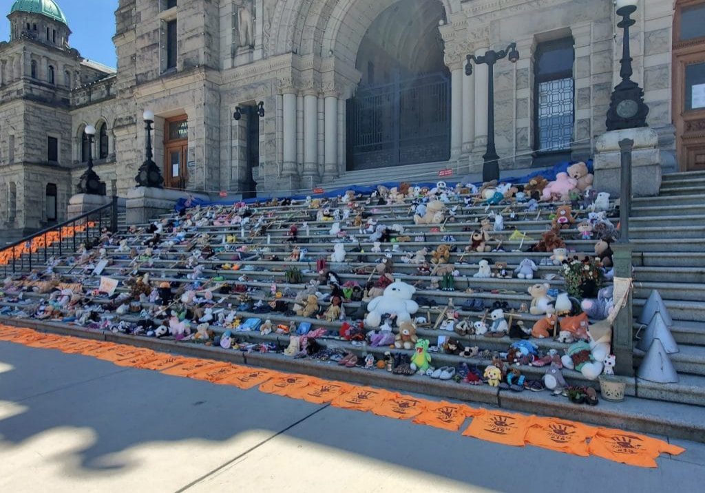 Childrens shoes and teddy bears on the steps of the Legislature in Victoria, BC